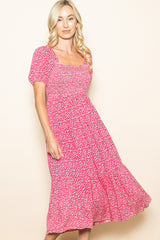 woman wearing a pink floral midi dress with short sleeves and a square neckline