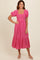woman wearing a pink floral midi dress with puff sleeves and a square neckline