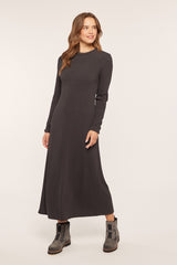 woman wearing a dark gray long sleeve maxi dress and black ankle boots