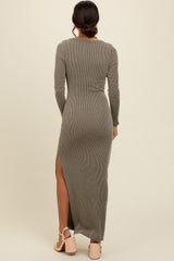 woman wearing a long ribbed olive green maxi dress with a side slit and long sleeves, viewed from the back