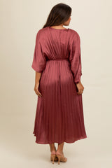 woman wearing a plum pleated maternity maxi dress with a cinched waist, seen from the back
