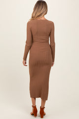 woman wearing a brown ribbed long sleeve maternity dress that reaches mid-calf length