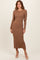 woman wearing a ribbed long sleeve midi dress in brown with a fitted silhouette and side slit