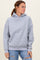 woman wearing a light gray oversized hoodie with a front pocket and long sleeves, paired with ripped jeans