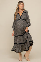woman wearing a floral print maternity dress with long sleeves and ruffle hem, showcasing her baby bump