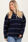 woman wearing a navy blue striped oversized sweater with a relaxed fit and long sleeves