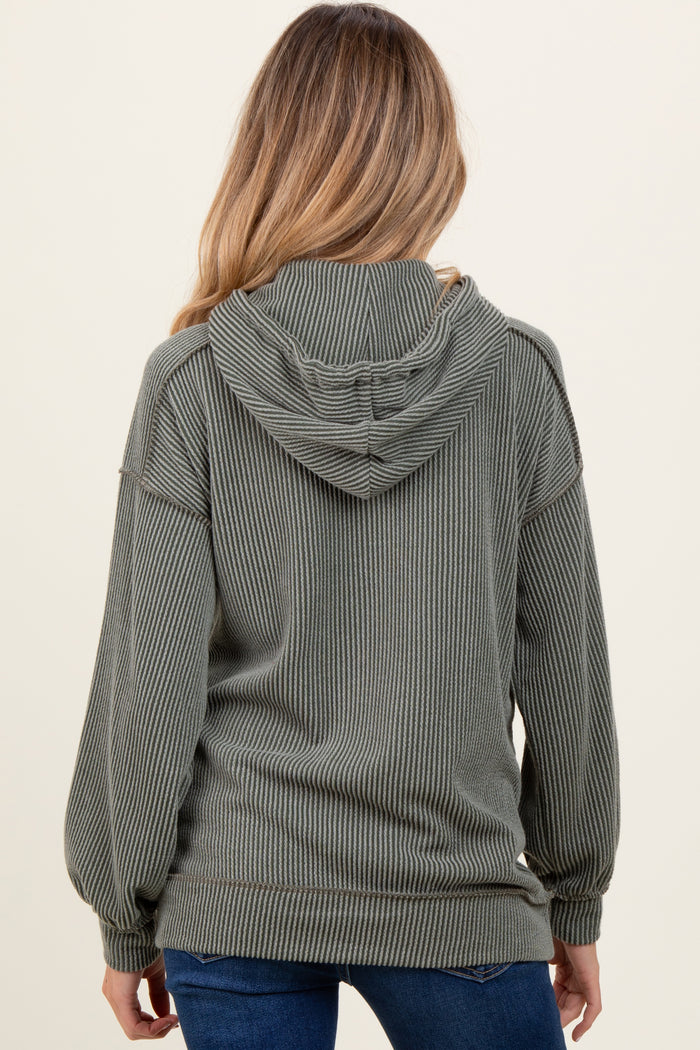 woman wearing a green ribbed hooded maternity sweatshirt, showing the back view with a relaxed fit