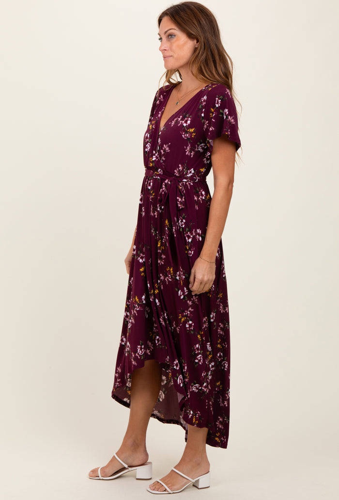 woman wearing a burgundy floral midi dress with a v-neck and short sleeves, tied at the waist