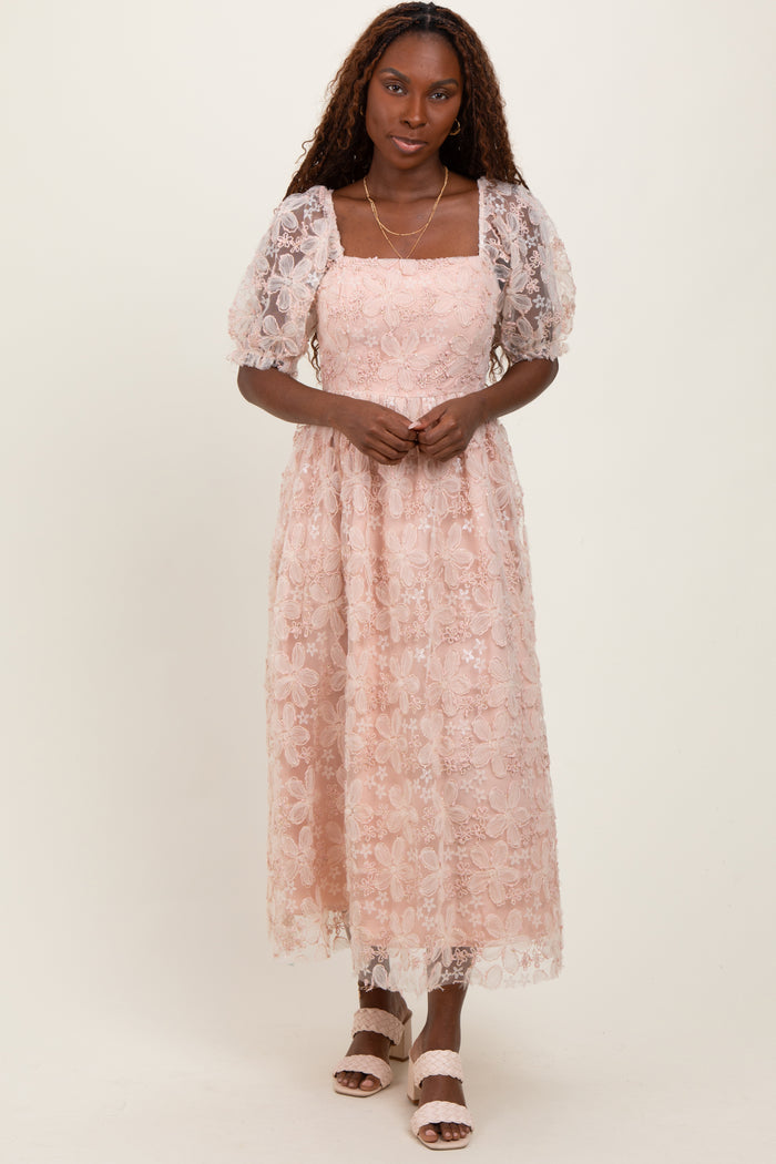 woman wearing a pink floral lace maxi dress with puff sleeves and a square neckline
