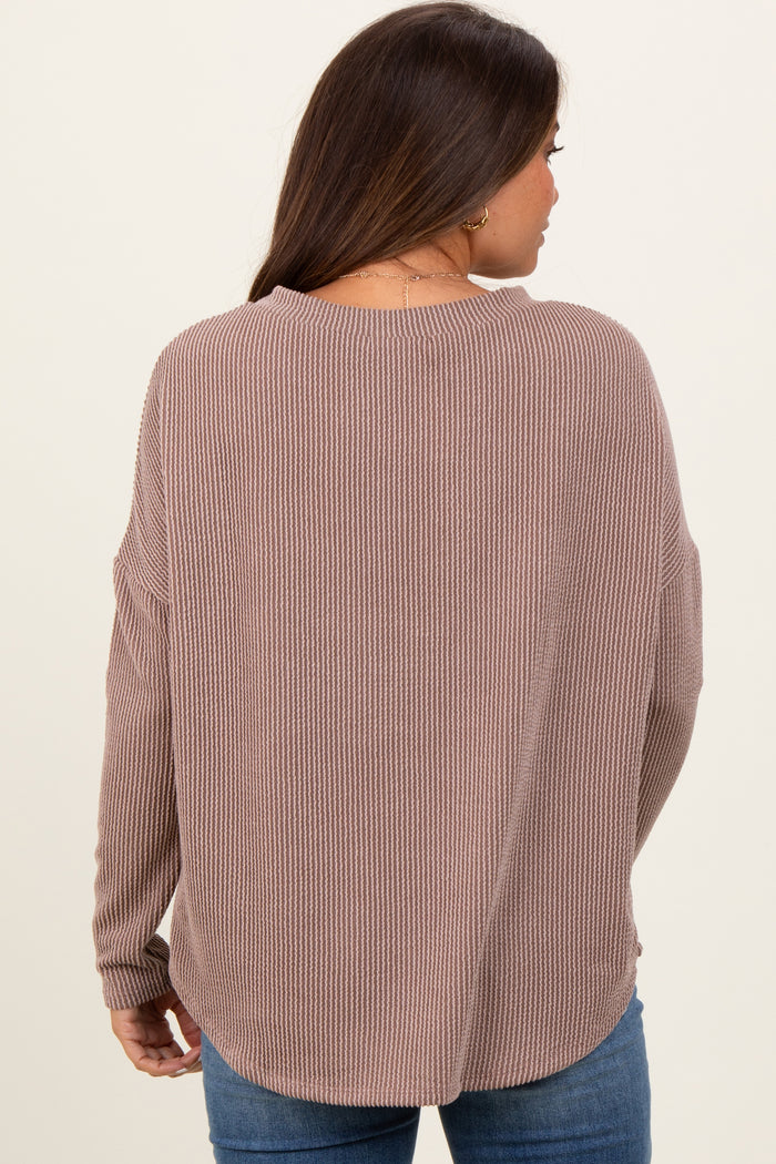 woman wearing a mauve ribbed maternity sweater with a relaxed fit