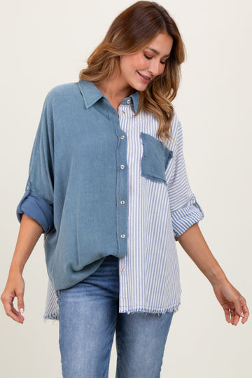 woman wearing a blue and white striped oversized button-up shirt with a chest pocket and rolled sleeves