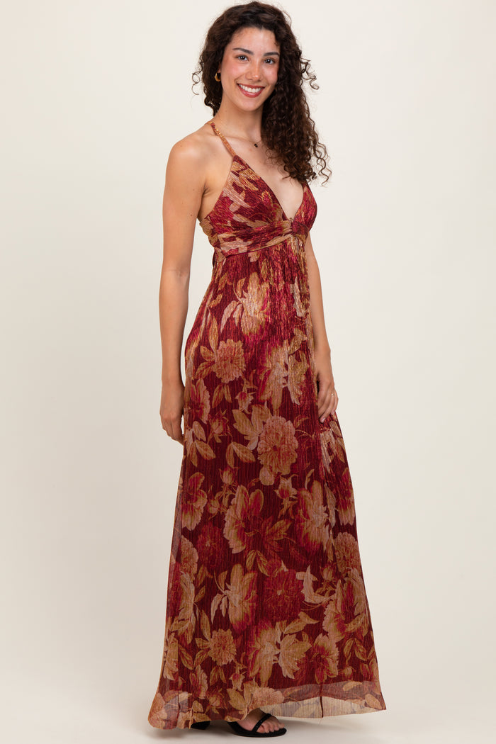 woman wearing a burgundy floral maxi dress with a deep v-neck and thin straps