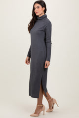 woman wearing a dark gray long sleeve midi dress with a turtle neck and side slit, styled with beige high heels