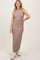 woman wearing a brown sleeveless knitted midi dress with a textured check pattern and standing in a neutral pose