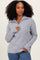 woman wearing a light grey zip-up sweater with a relaxed fit and ribbed detailing, posing confidently
