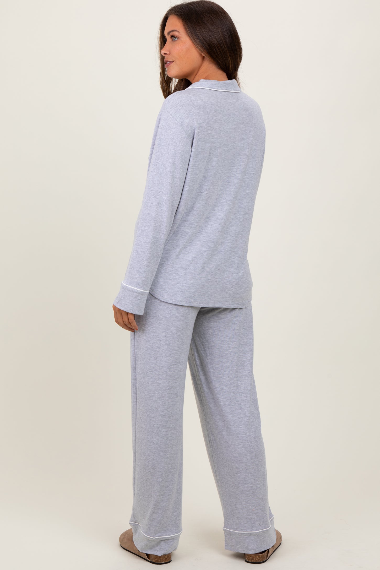 woman wearing a gray long sleeve maternity pajama set with matching pants, showcasing a relaxed fit from the back