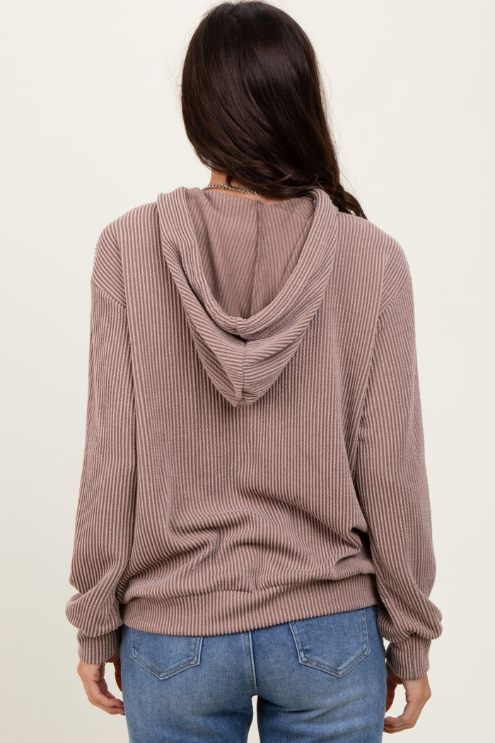 woman wearing a mauve ribbed hoodie with a relaxed fit and back view, paired with blue jeans
