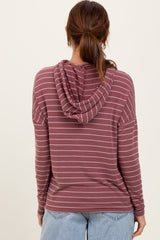 woman wearing a burgundy and white striped long sleeve hoodie with a drawstring hood, viewed from the back