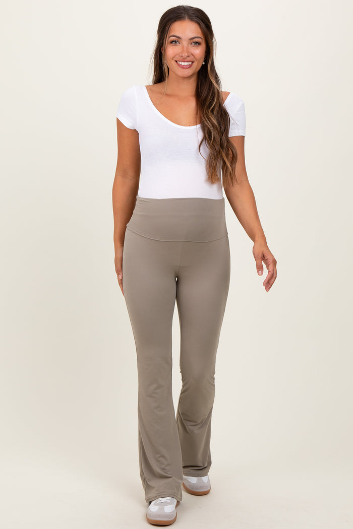 woman wearing a white short sleeve maternity top and beige flared maternity pants