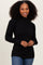 woman wearing a black ribbed turtleneck sweater with puff sleeves and styled hair