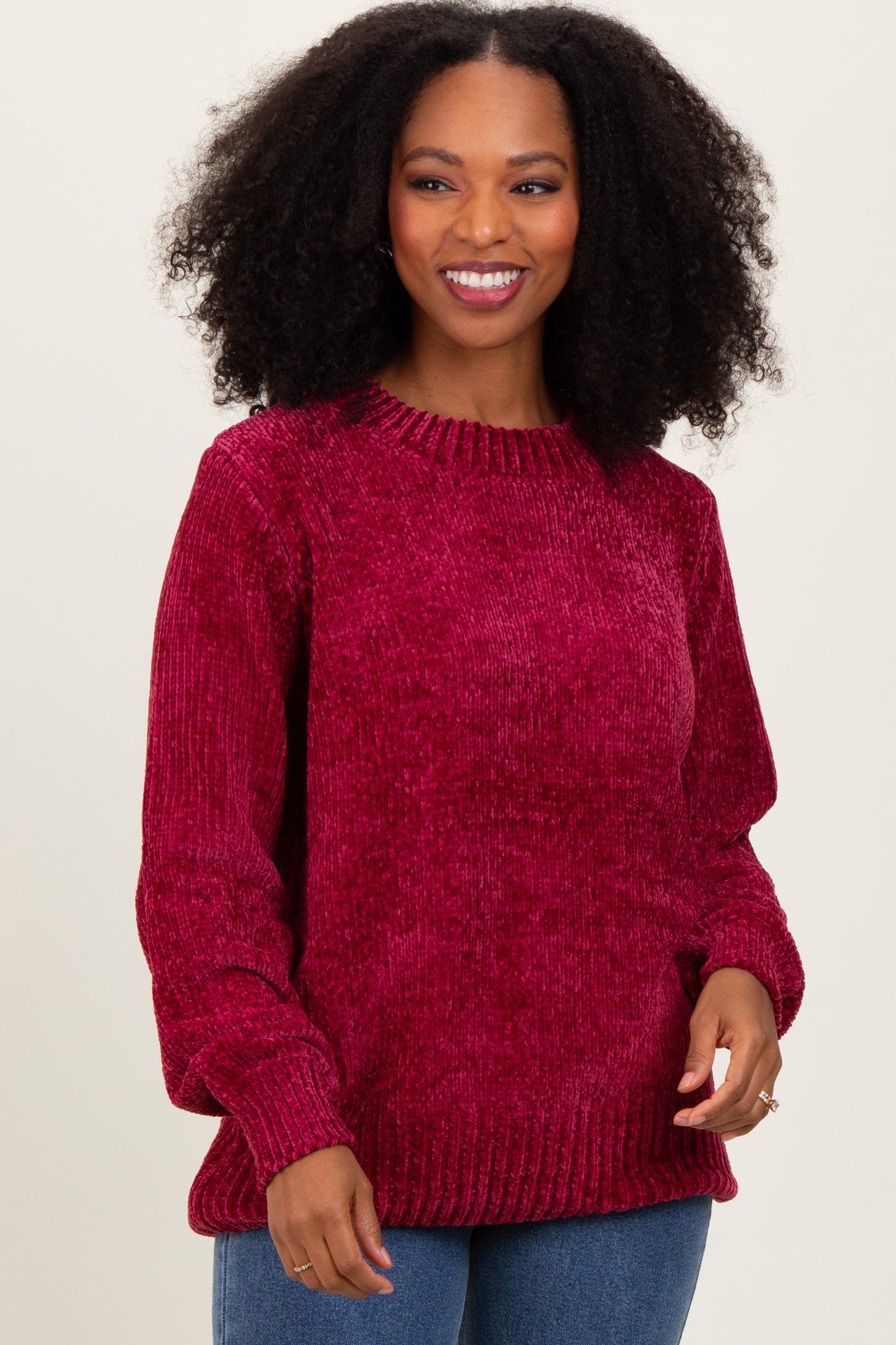 woman wearing a cozy burgundy ribbed knit sweater with long sleeves and a relaxed fit