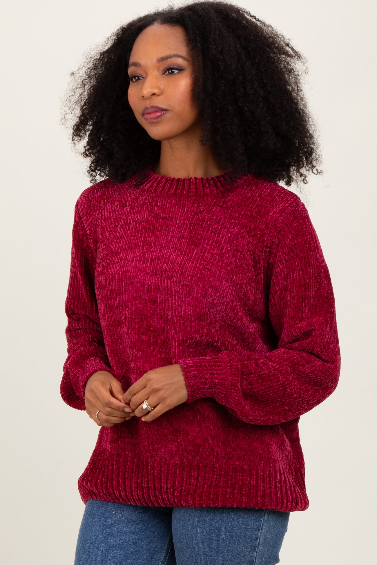 woman wearing a red textured long sleeve sweater with a round neckline and relaxed fit
