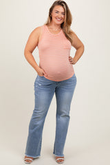 woman wearing a striped orange maternity tank top with a baby bump and flared light blue maternity jeans