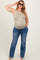 woman wearing a striped tank top and blue flared jeans, showing her baby bump and wearing sunglasses