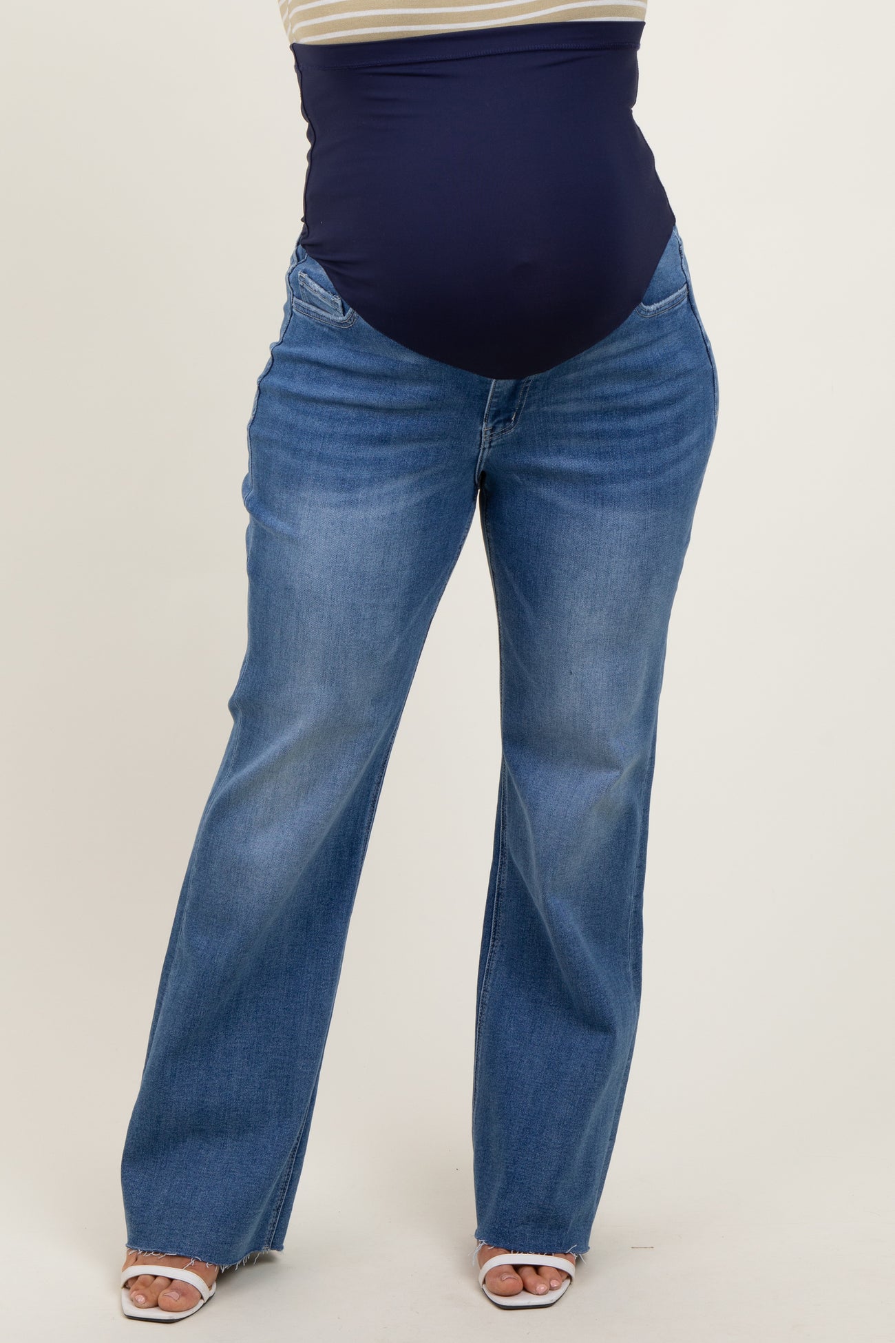 woman wearing dark blue maternity plus jeans with a wide waistband and a relaxed fit