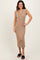 woman wearing a tan ribbed midi dress with cap sleeves and button detailing, standing with one hand on her hip