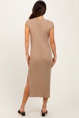 woman wearing a beige ribbed maxi dress with a high slit and cap sleeves, seen from the back