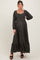 woman wearing a black floral print maternity maxi dress with long sleeves and a square neckline, showing a baby bump