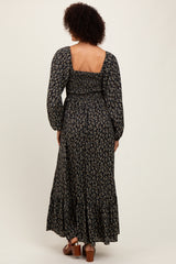 woman wearing a floral long sleeve maxi dress with a square back and tiered hem, viewed from the back