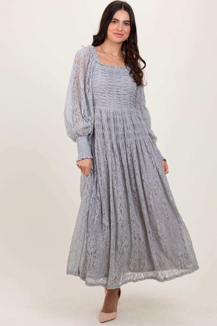 woman wearing a light grey long sleeve midi dress with lace overlay and puff sleeves