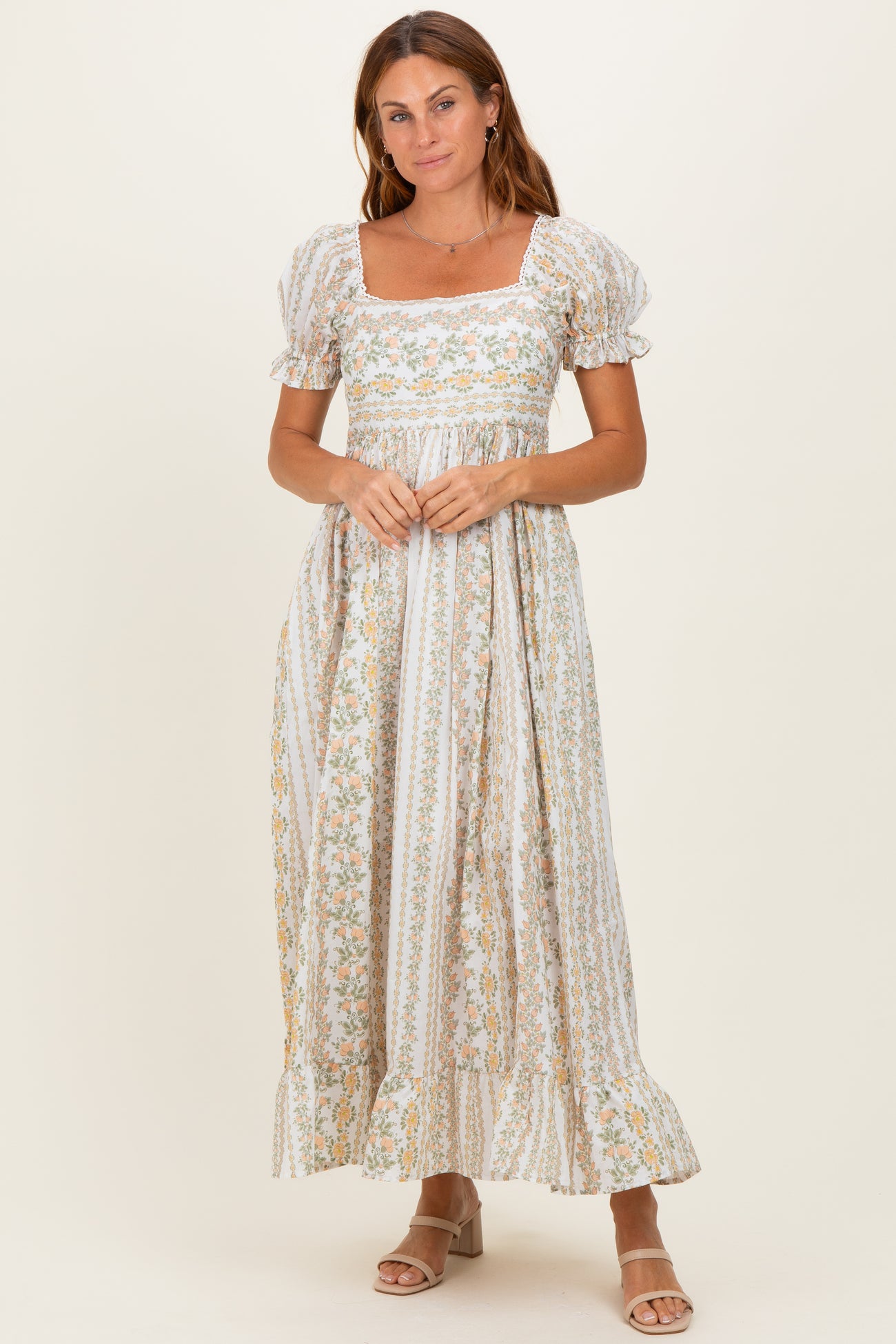 woman wearing a floral print maxi dress with puff sleeves and a square neckline