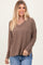 woman wearing a brown ribbed long sleeve v-neck top with relaxed fit and soft fabric