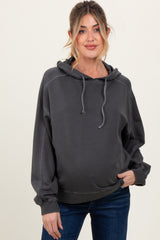 woman wearing a dark gray maternity hoodie with a relaxed fit and visible baby bump