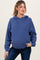 woman wearing a dark blue maternity hoodie with a relaxed fit and drawstring hood, paired with dark jeans