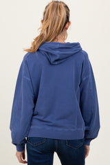 woman wearing a blue maternity hoodie with a relaxed fit and a hood, shown from the back