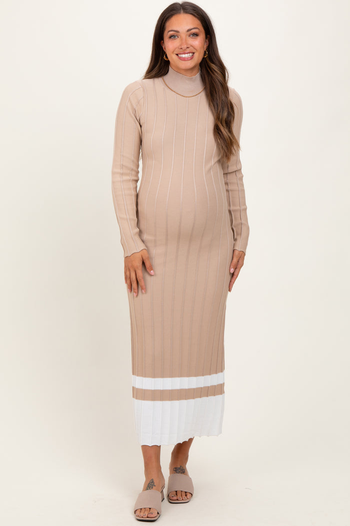 woman wearing a beige maternity dress with long sleeves and a ribbed texture, showing her baby bump