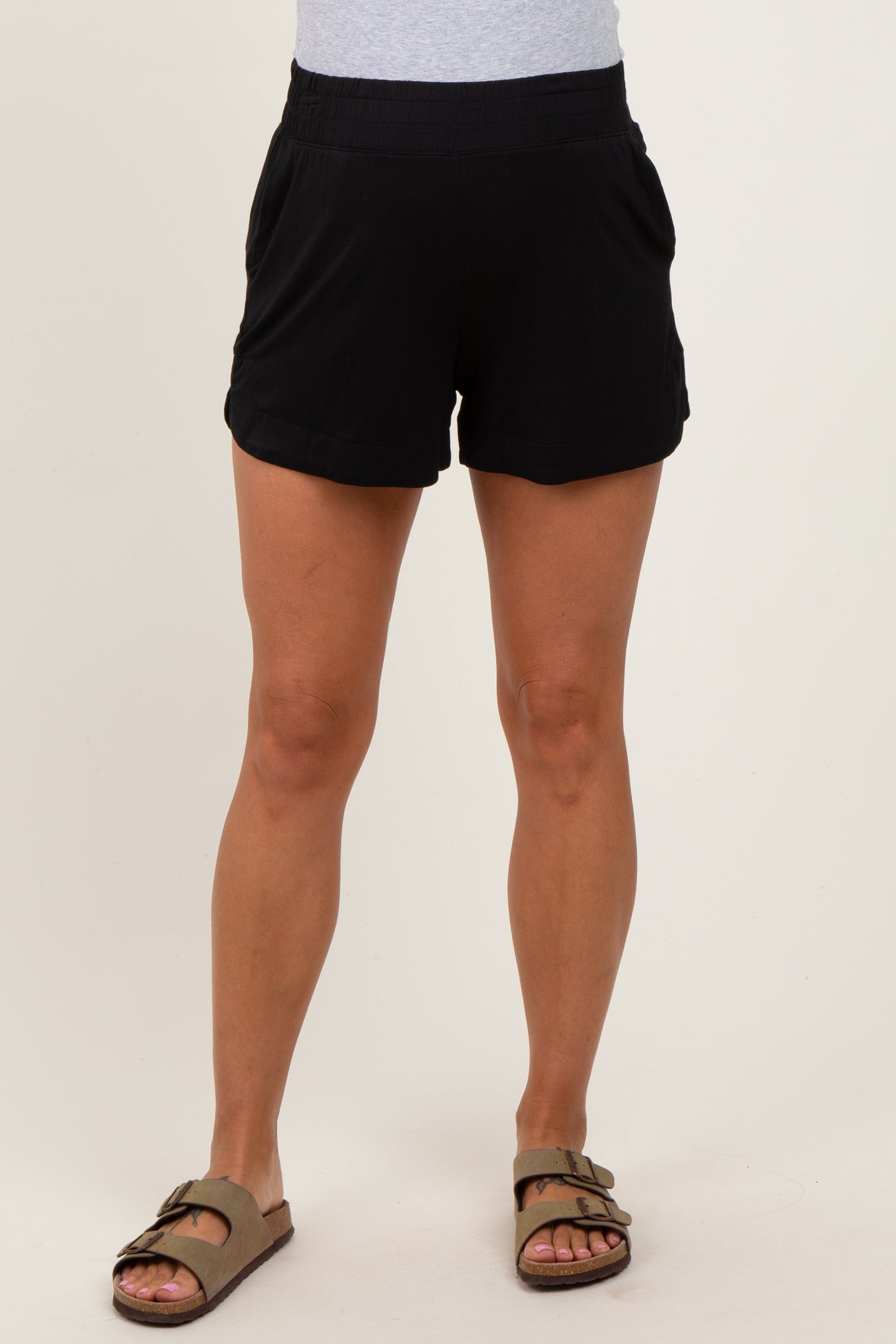 woman wearing black maternity shorts with an elastic waistband and side pockets