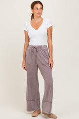 woman wearing a white short sleeve ribbed top and light purple wide-leg pants with pockets