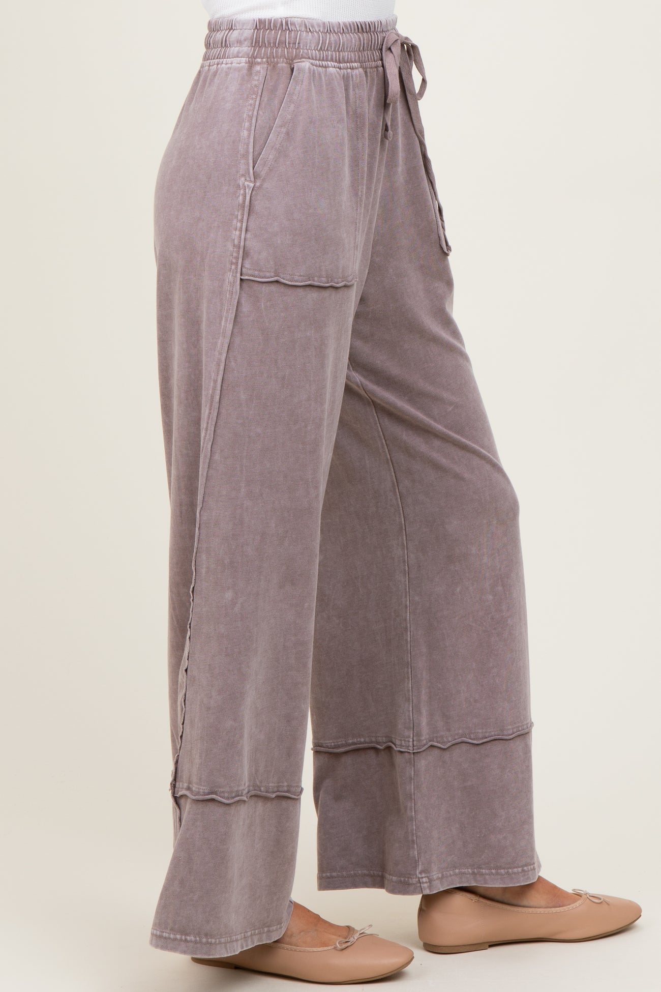 woman wearing loose-fitting lavender wide-leg pants with an elastic waistband and side pockets