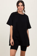 woman wearing an oversized black t-shirt with short sleeves and black bike shorts