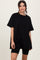 woman wearing an oversized black t-shirt with short sleeves and black bike shorts