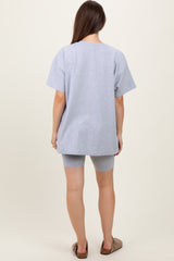 woman wearing a gray oversized t-shirt paired with matching shorts, showing a relaxed maternity style