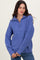 woman wearing a soft purple knit sweater with a half zip and relaxed fit, styled with blue jeans