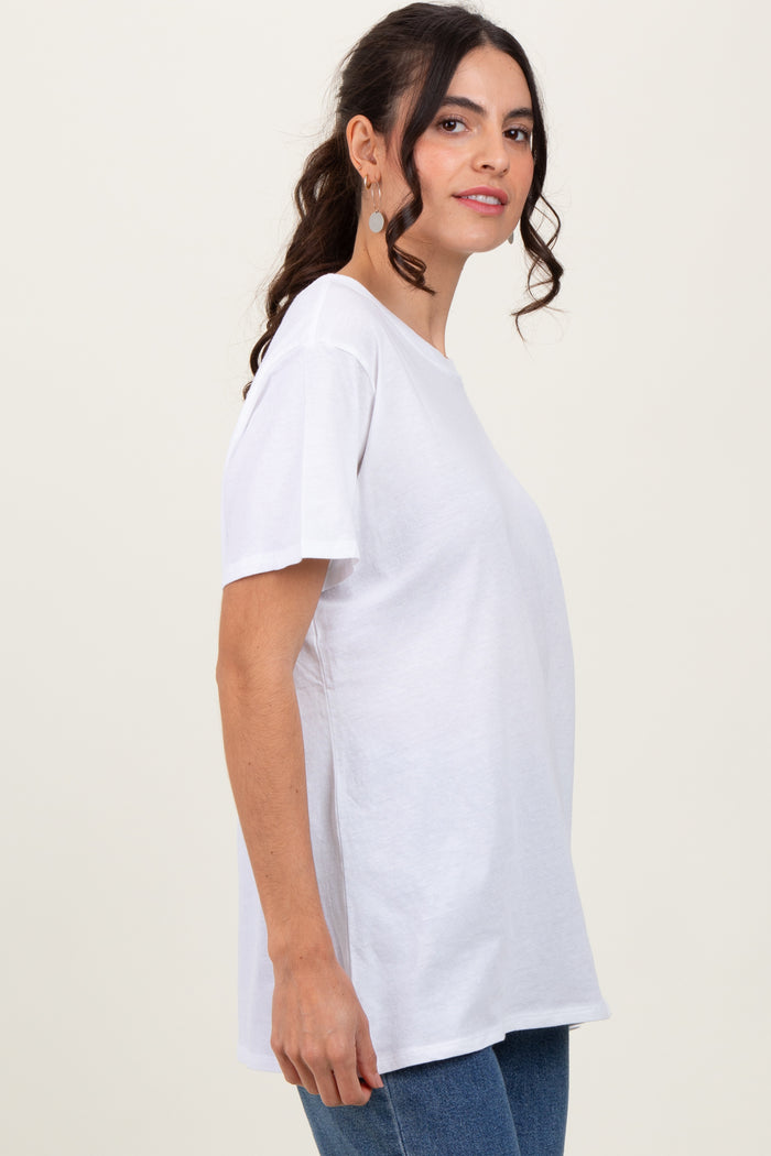 woman wearing a white short sleeve t-shirt with a relaxed fit and standing sideways