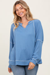 woman wearing a blue long sleeve pullover top with a v-neck and relaxed fit