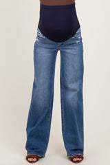 maternity wear dark blue high-waisted jeans with distressed details, worn by a model with a visible baby bump
